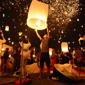 A lit sky lantern (khom loi) is prepared to be released at the Yi Peng festival at Mae Jo University in Chiang Mai, Thailand.